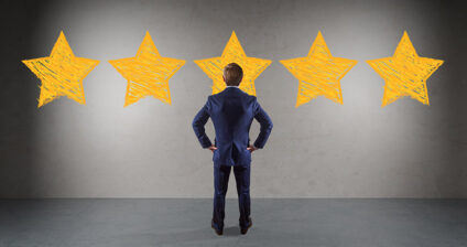 man facing five large yellow stars on wall