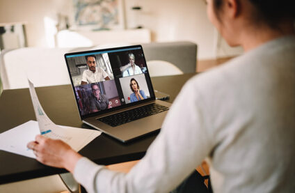 woman on video conference with four other people