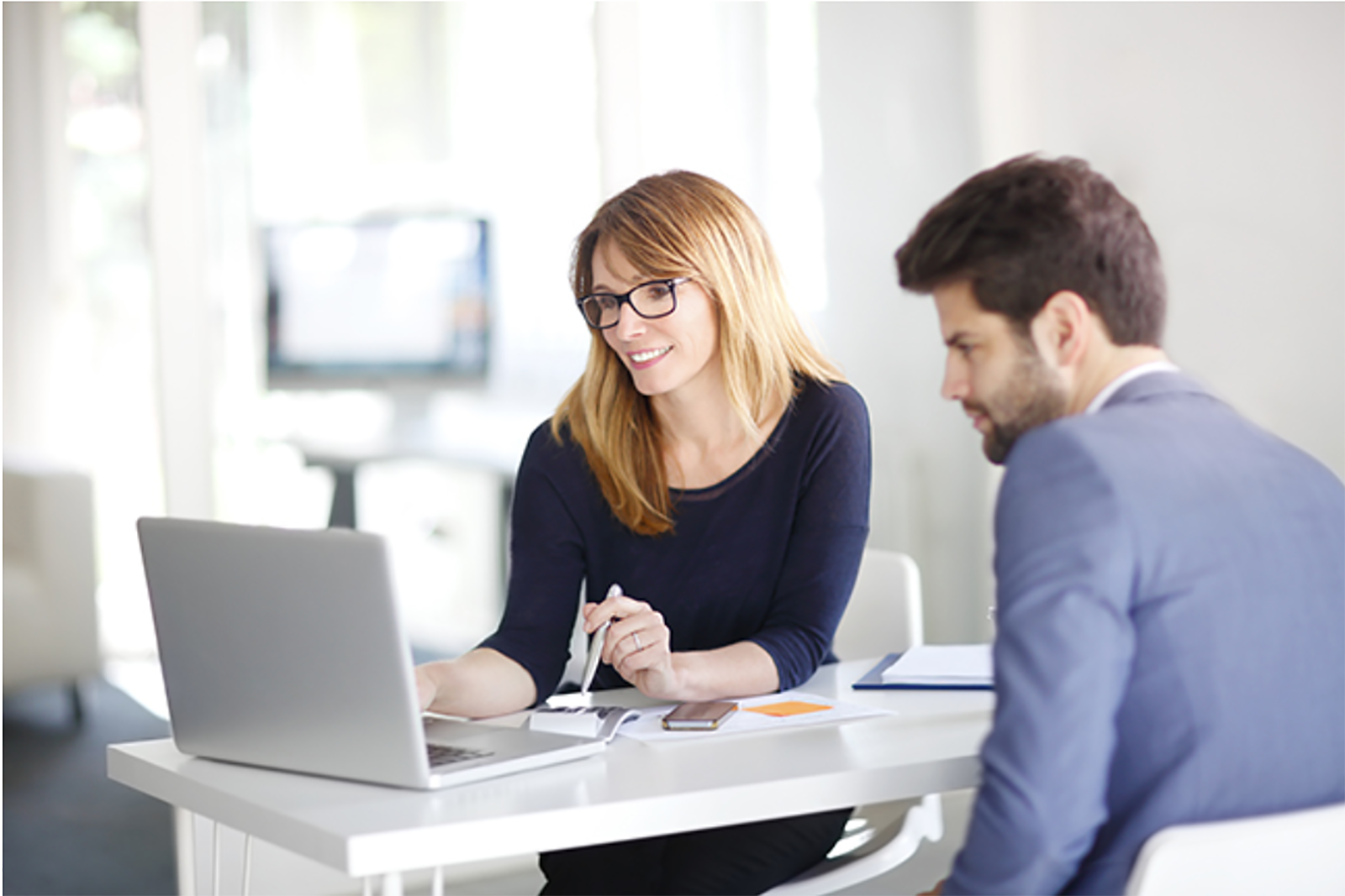 woman and man looking at laptop screen