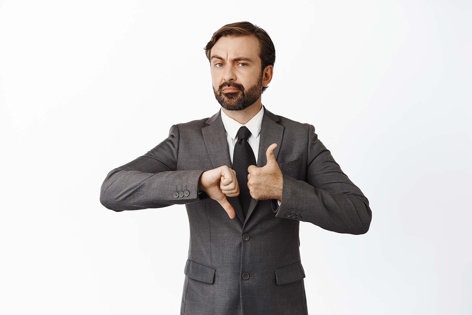 man wearing suit, pointing one thumb up, one down