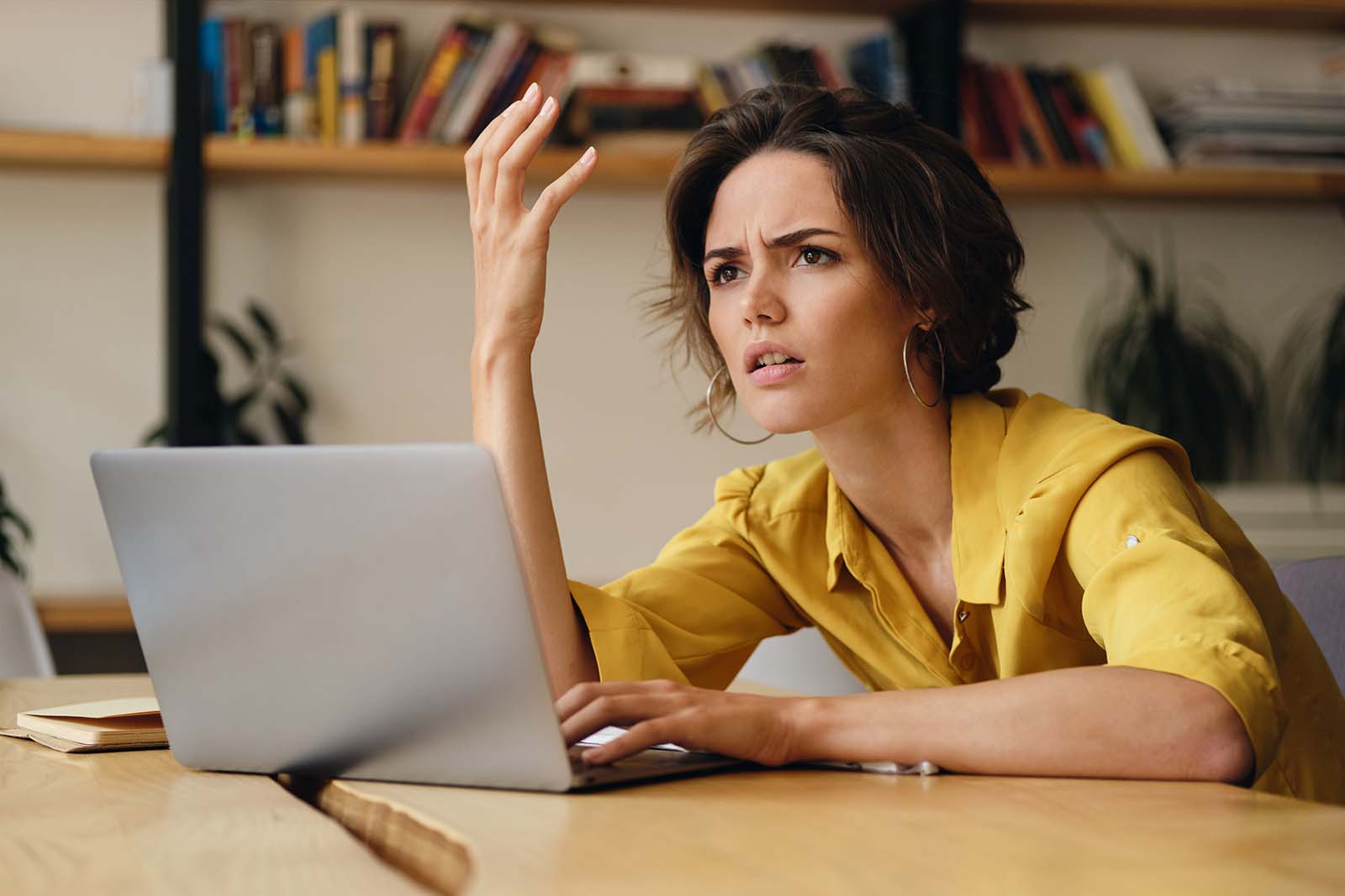 frustrated woman typing on laptop