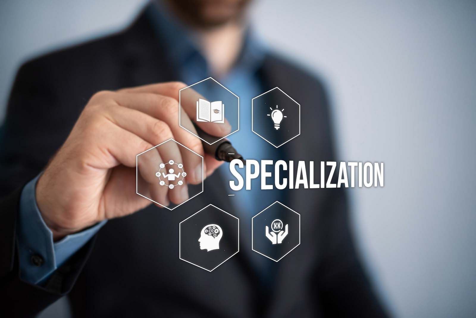 man holding pen touching the word "specialization" floating in air with symbols