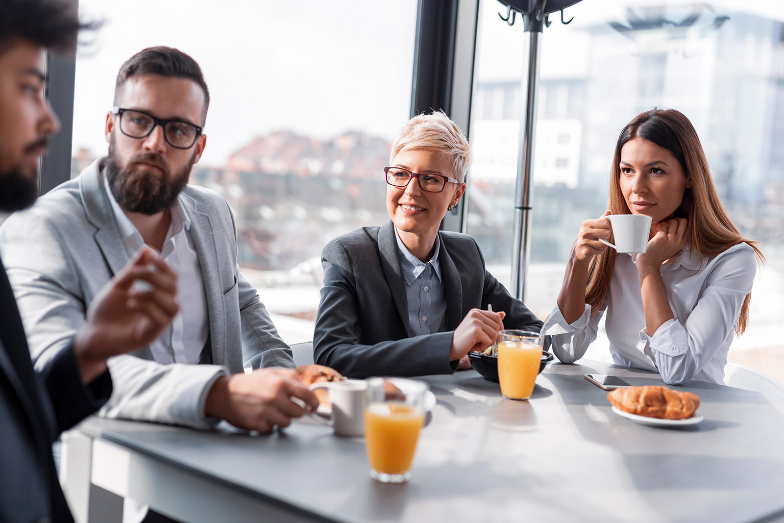 four people eating together
