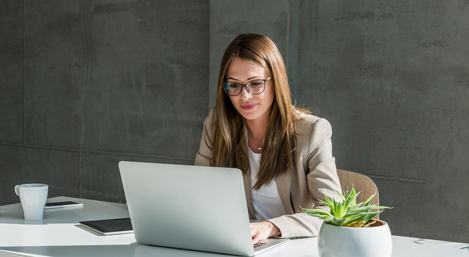 woman working on laptop in office setting