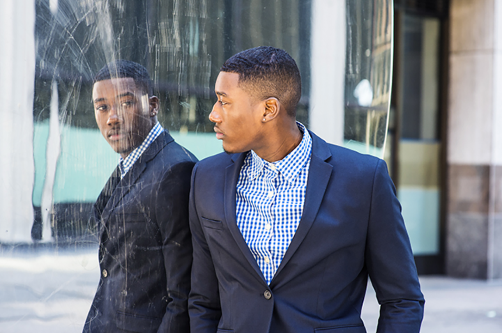 Young black businessman looking at his reflection