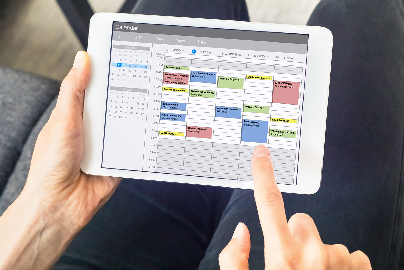 woman using calendar planner on tablet