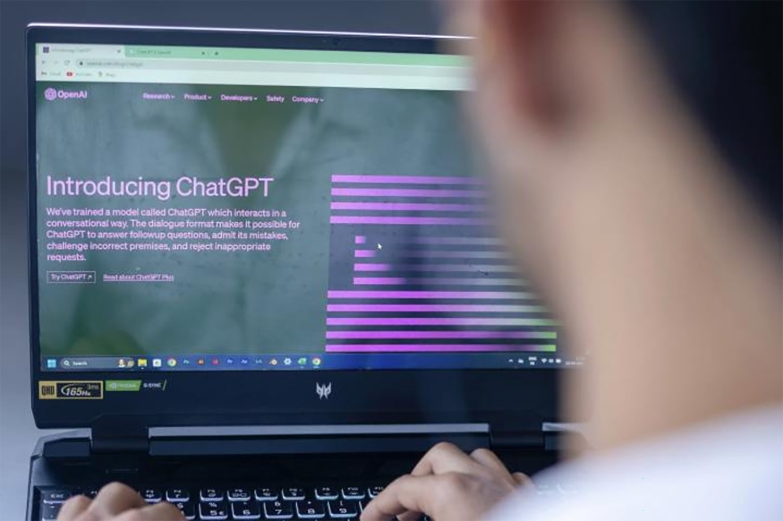 man reading about ChatGPT on computer screen