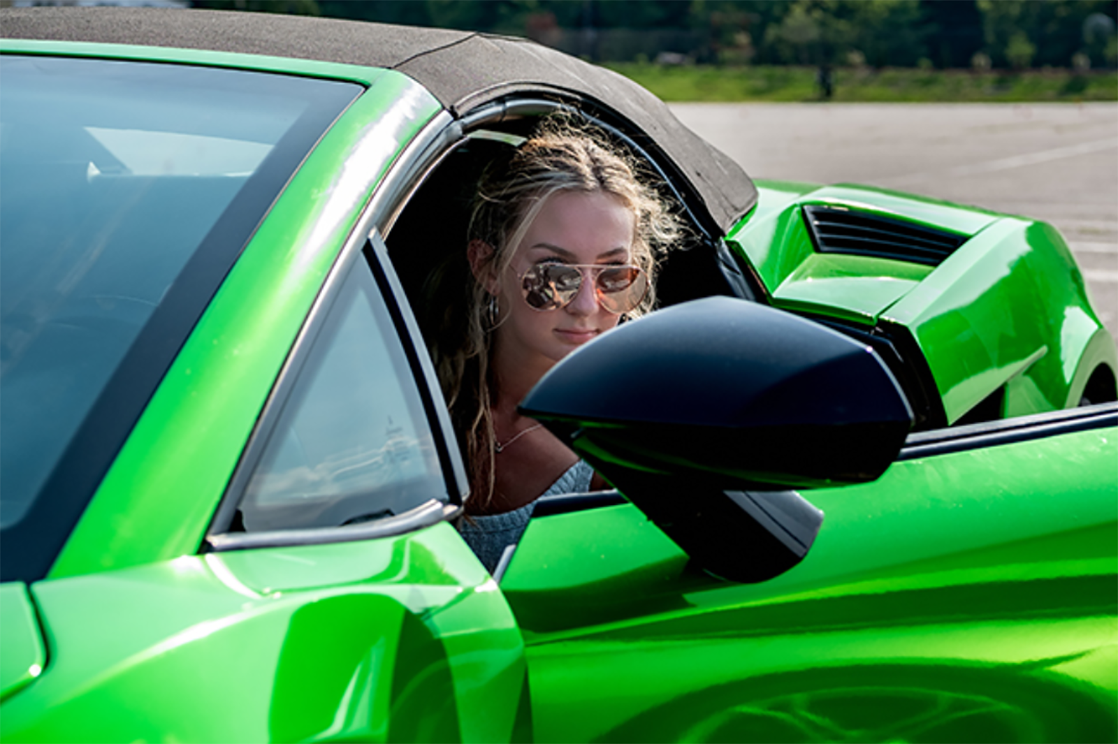 woman driving green sports car