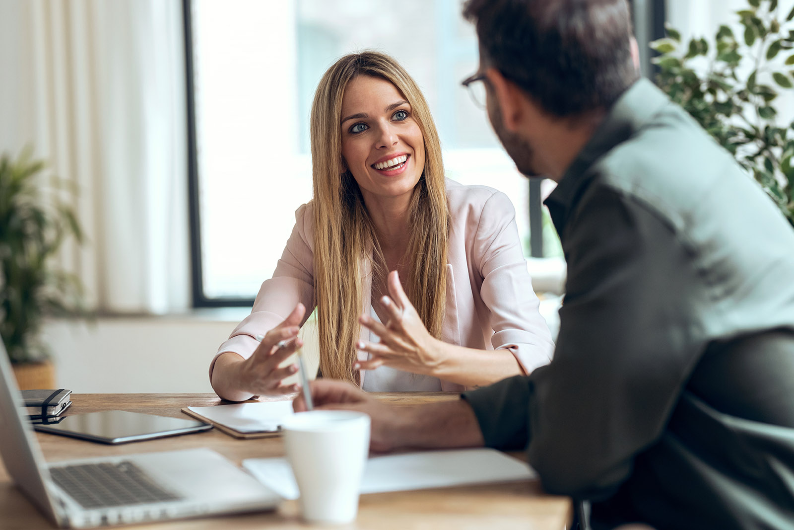 young woman talking to man in office