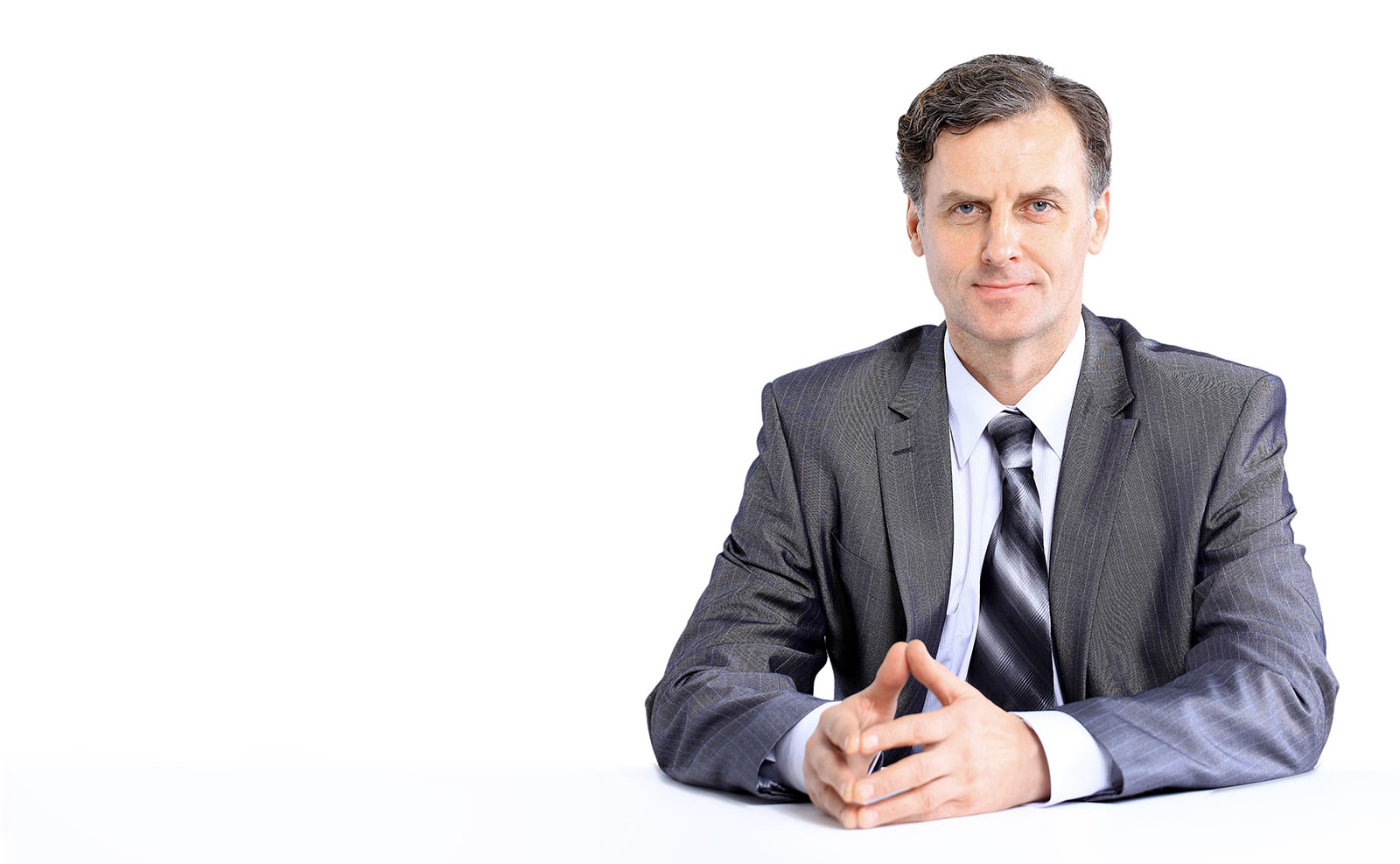 seated man wearing suit looking straight ahead