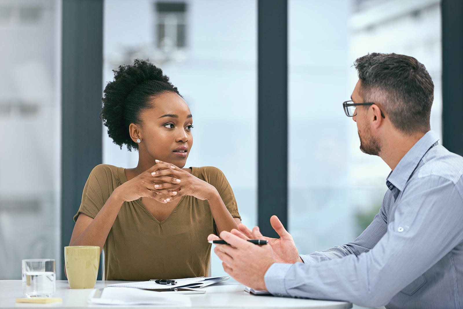 woman and man talking in office