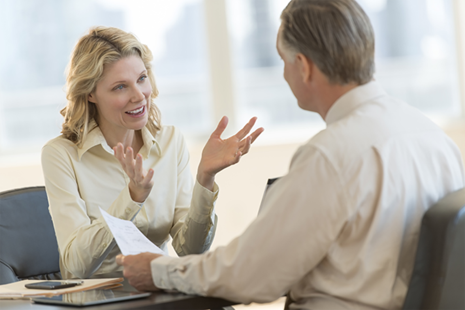 woman and man smiling and talking in business setting