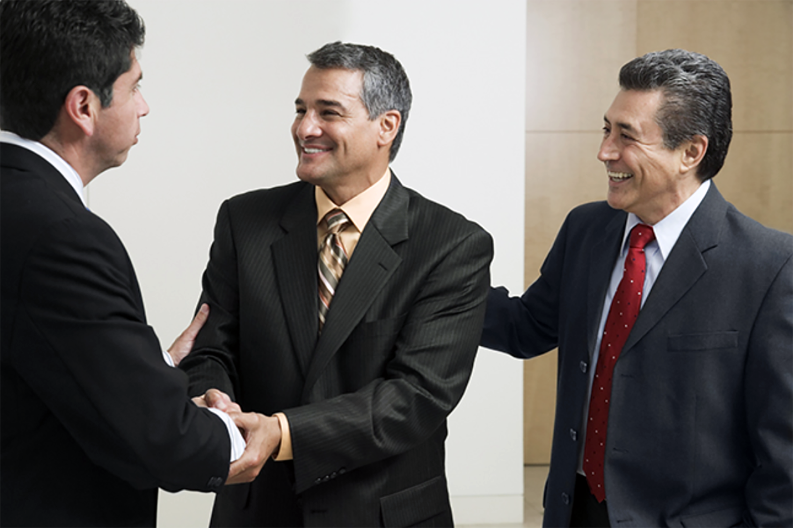 three businessmen sharing handshake