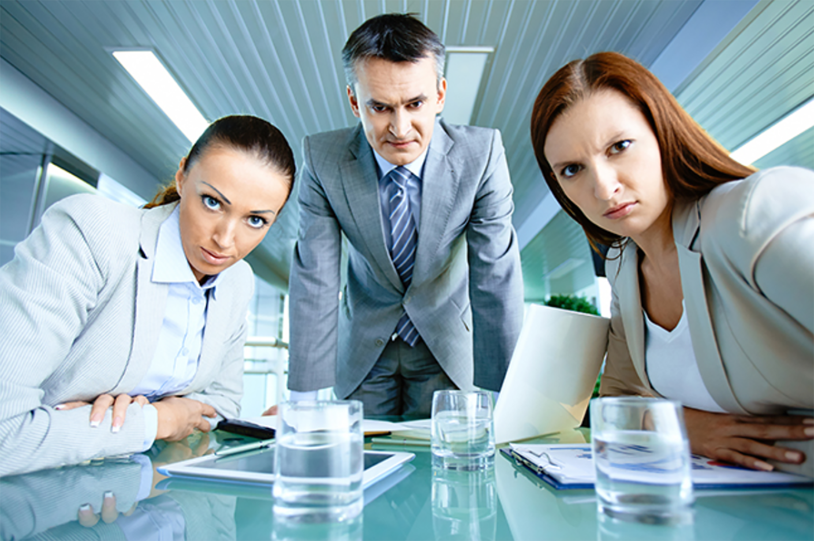 Three office workers glaring at camera