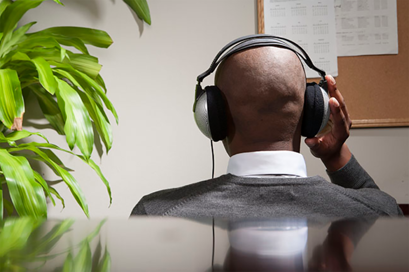 Businessman listening to music in office
