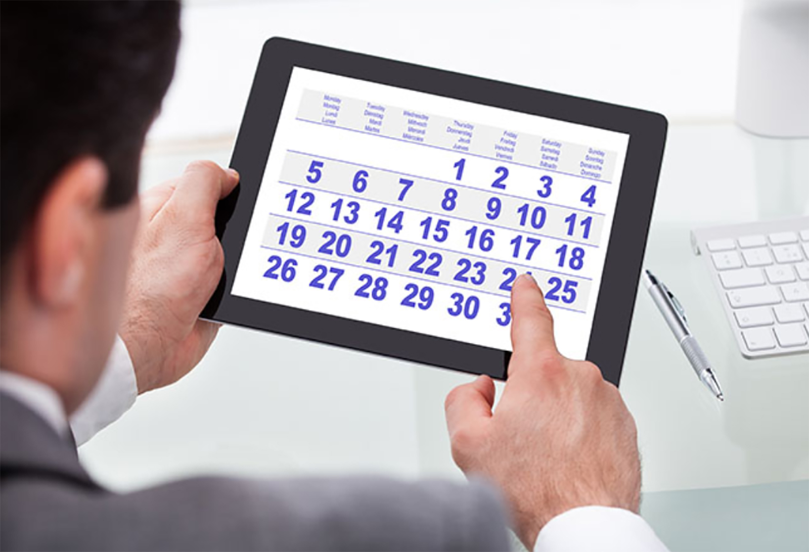 Businessman looking at calendar on tablet