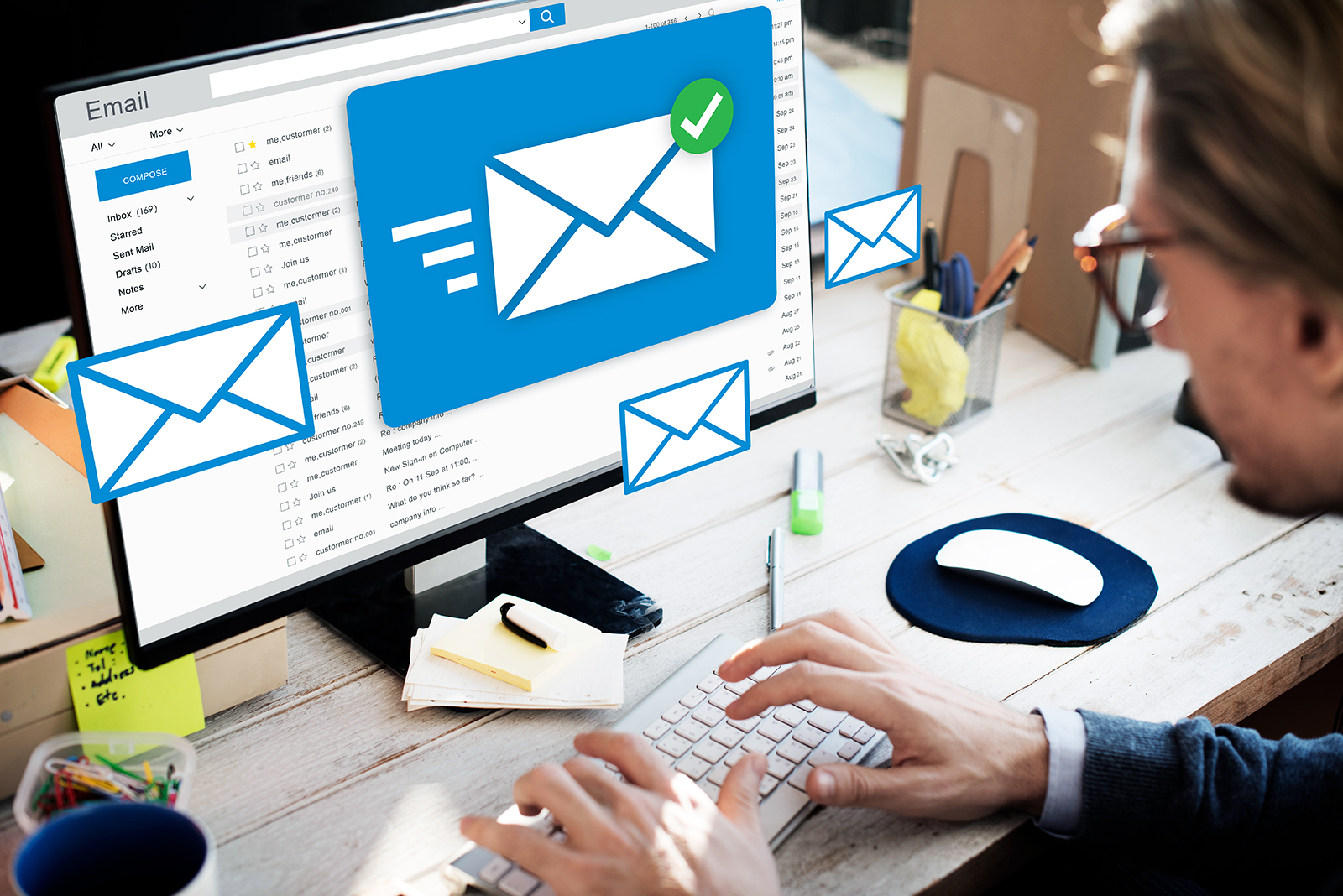 man displaying emails on computer screen