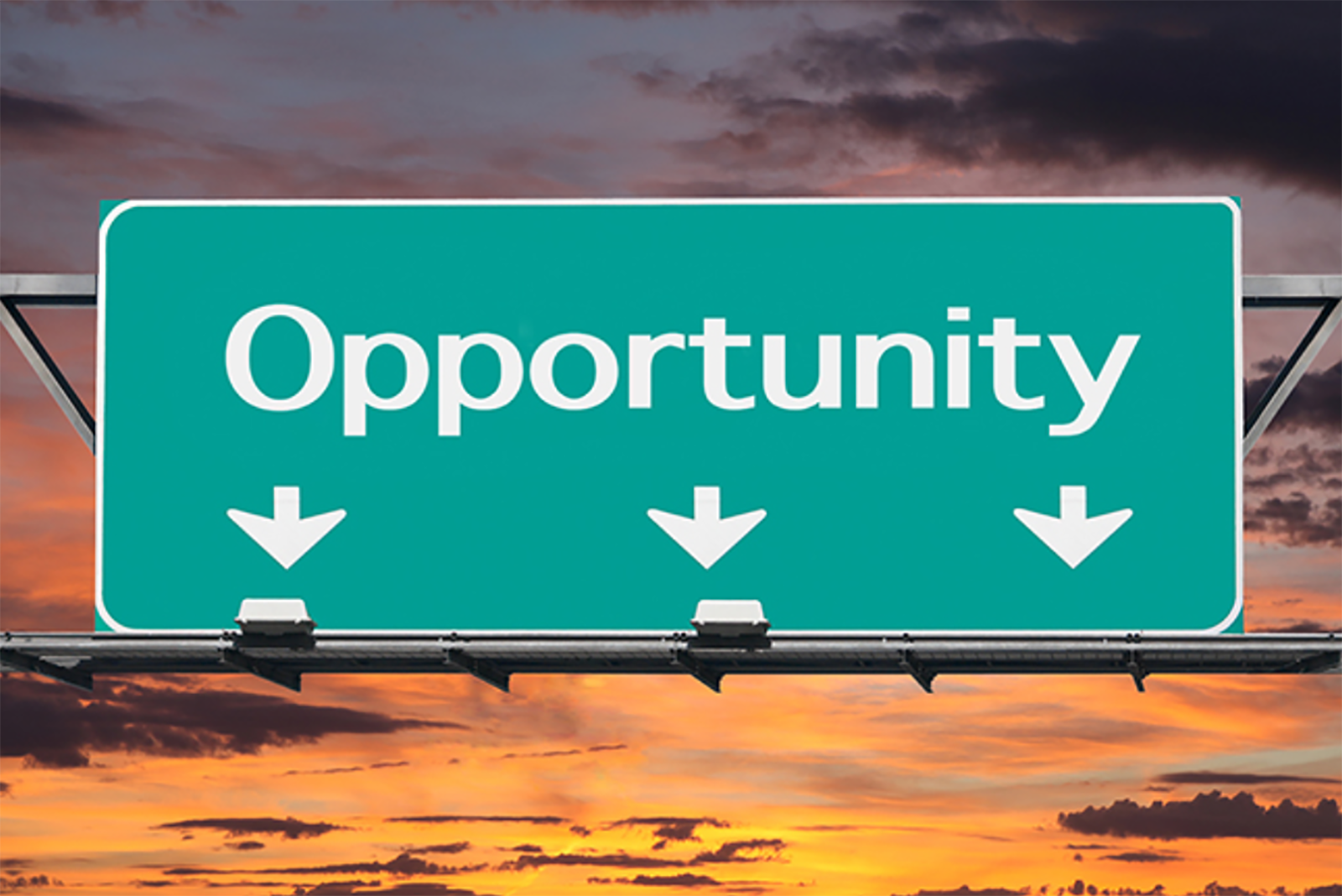 Green "opportunity" highway sign with sunrise background