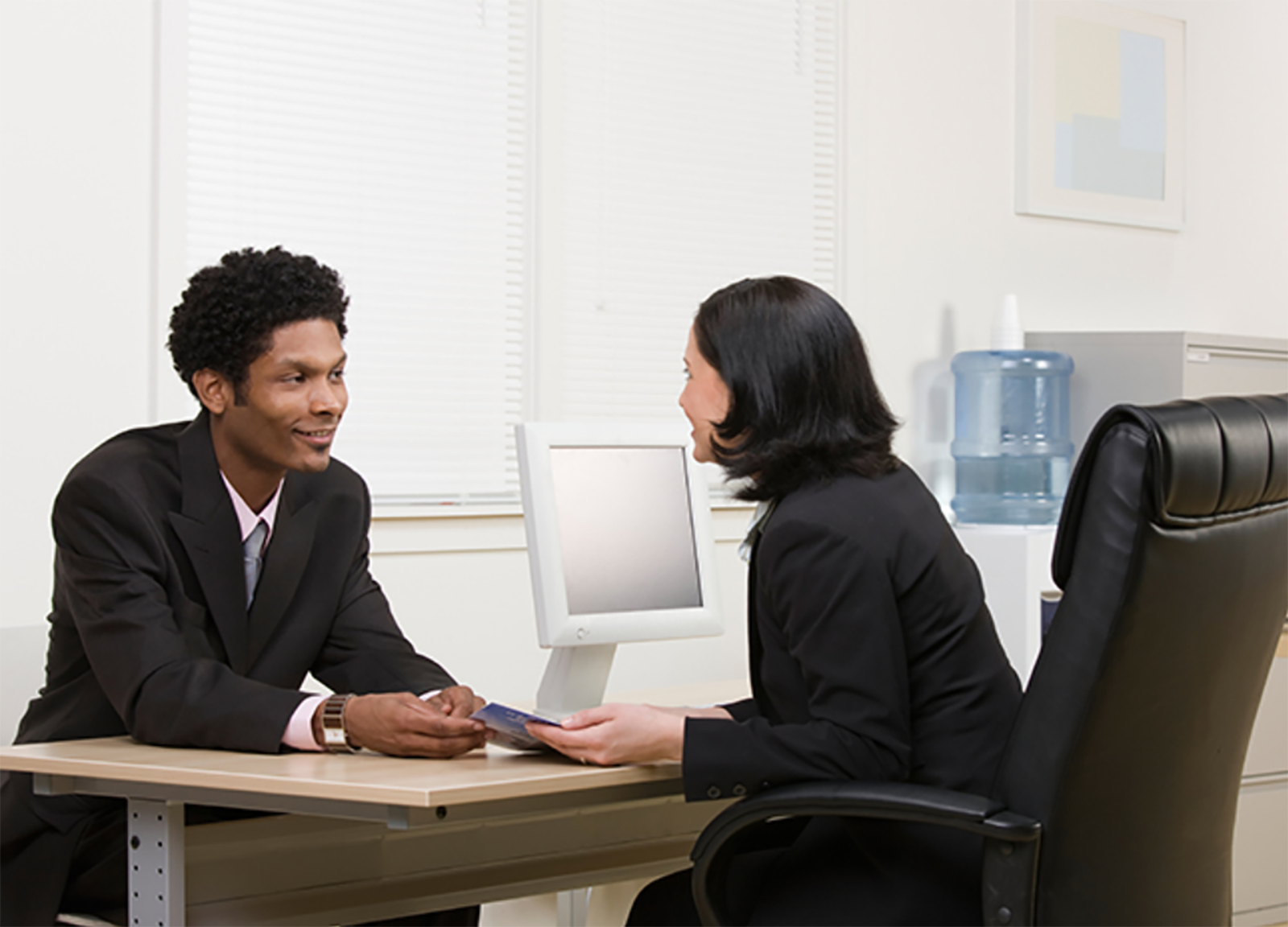 Woman explaining financial brochure to man