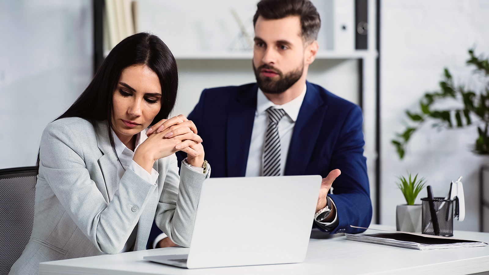 woman looking away from man in office